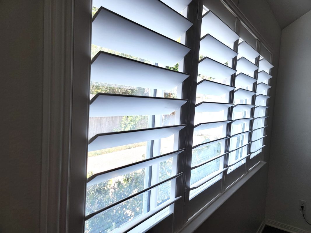 Interior view of custom plantation shutters in Houston – Elegant window treatments for privacy, light control, and energy efficiency.